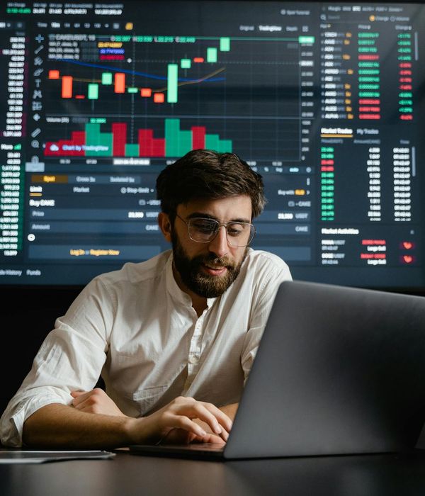 modern financial analytics office with multiple screens displaying market data and fund performance